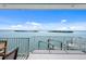 Balcony overlooking water and a boat lift, offering a serene outdoor space and access to boating amenities at 1900 Illinois Ave, Englewood, FL 34224