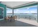 Spacious outdoor balcony featuring a dining table and chairs, providing picturesque waterfront views and outdoor living at 1900 Illinois Ave, Englewood, FL 34224
