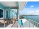 Balcony view of a pool and waterfront, with outdoor seating and coastal charm for relaxed living at 1900 Illinois Ave, Englewood, FL 34224