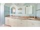 Bathroom features double sinks with granite counters and arched mirrors at 1900 Illinois Ave, Englewood, FL 34224