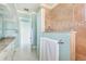 Bathroom with a granite countertop and tiled shower separated by a glass door at 1900 Illinois Ave, Englewood, FL 34224