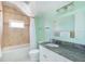 Bathroom featuring a shower-tub combo and granite vanity at 1900 Illinois Ave, Englewood, FL 34224