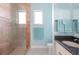 Bathroom with tiled shower, granite counters and blue accent at 1900 Illinois Ave, Englewood, FL 34224