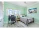 Inviting bedroom featuring a desk, comfortable bed, and sunlit windows at 1900 Illinois Ave, Englewood, FL 34224