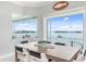 Bright dining area with large windows overlooking the water and seating for six at 1900 Illinois Ave, Englewood, FL 34224