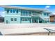 Stunning waterfront home featuring a spacious patio and a staircase leading to a second-story balcony with water views at 1900 Illinois Ave, Englewood, FL 34224