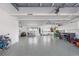 Spacious garage with epoxy flooring, ample storage, and workshop area and lots of windows with waterview at 1900 Illinois Ave, Englewood, FL 34224