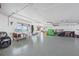 Large garage with epoxy flooring, workshop area, ample storage and natural light with waterview windows at 1900 Illinois Ave, Englewood, FL 34224