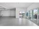 Expansive garage with epoxy flooring, and large sliding glass doors that provide access to the pool area at 1900 Illinois Ave, Englewood, FL 34224