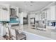 Luxurious kitchen featuring stainless steel appliances, a large island, and stylish white cabinetry at 1900 Illinois Ave, Englewood, FL 34224