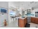 Gourmet kitchen features stainless steel appliances, custom cabinetry, an island, and great views at 1900 Illinois Ave, Englewood, FL 34224