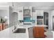 Gourmet kitchen featuring quartz countertops, stainless steel appliances, and custom cabinetry at 1900 Illinois Ave, Englewood, FL 34224