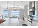 Spacious kitchen with white quartz countertops, stainless appliances, and waterfront views at 1900 Illinois Ave, Englewood, FL 34224