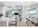 Open-concept living space featuring a modern kitchen, dining area, and a cozy living room with water views at 1900 Illinois Ave, Englewood, FL 34224