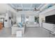 Bright, open living room with tile floors, ceiling fans and stylish, comfortable furniture at 1900 Illinois Ave, Englewood, FL 34224