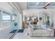 Open concept living room with access to kitchen and balcony overlooking water at 1900 Illinois Ave, Englewood, FL 34224