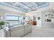Bright living room area with access to kitchen and balcony overlooking water at 1900 Illinois Ave, Englewood, FL 34224
