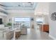 Open concept living room with a balcony overlooking water and access to kitchen at 1900 Illinois Ave, Englewood, FL 34224