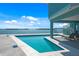 Beautiful waterfront backyard featuring a refreshing pool and comfortable lounge chairs perfect for relaxing and enjoying the view at 1900 Illinois Ave, Englewood, FL 34224