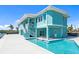 Beautiful turquoise waterfront home featuring a private pool and outdoor entertainment space at 1900 Illinois Ave, Englewood, FL 34224