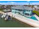 Waterfront home with private dock, boat lift, pool, and spacious patio for outdoor enjoyment at 1900 Illinois Ave, Englewood, FL 34224