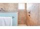 Tiled shower featuring a mounted showerhead and glass door in bathroom at 1900 Illinois Ave, Englewood, FL 34224