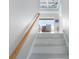 Bright staircase leading to a living space with light blue coffered ceilings and a ceiling fan with waterfront view at 1900 Illinois Ave, Englewood, FL 34224