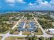 High-angle view of quaint waterfront homes nestled amidst lush trees and beautiful waterways in a vibrant coastal community at 1965 Louisiana Ave, Englewood, FL 34224