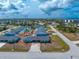Aerial view of the blue house with an inviting pool, surrounded by a well-maintained community at 1965 Louisiana Ave, Englewood, FL 34224