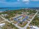 Expansive aerial view of coastal community featuring charming light blue homes, lush greenery, and stunning waterfront vistas at 1965 Louisiana Ave, Englewood, FL 34224