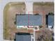 Top-down view of a cozy home with a patio, surrounded by manicured landscaping and neighboring residences in a tranquil neighborhood at 1965 Louisiana Ave, Englewood, FL 34224