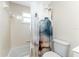 Bright bathroom with a tub and shower combination with tile surround and a window at 1965 Louisiana Ave, Englewood, FL 34224