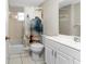 Bright bathroom with a tub and shower combination, tile flooring, and a vanity sink with storage at 1965 Louisiana Ave, Englewood, FL 34224