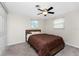 Cozy bedroom with neutral carpeting, two windows, a ceiling fan, and a closet at 1965 Louisiana Ave, Englewood, FL 34224