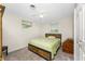 Cozy bedroom with a ceiling fan, carpet flooring, and natural light at 1965 Louisiana Ave, Englewood, FL 34224