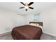 Bright bedroom featuring a ceiling fan, neutral carpeting, and a closet at 1965 Louisiana Ave, Englewood, FL 34224