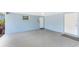 Functional carport with a smooth concrete floor, offering covered parking and access to storage and the house at 1965 Louisiana Ave, Englewood, FL 34224