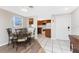 Bright dining area features decorative table set and leads to a kitchen with white appliances and tile flooring at 1965 Louisiana Ave, Englewood, FL 34224