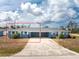 Charming duplex featuring a shared driveway, beautiful landscaping, and a classic design with a light-blue exterior at 1965 Louisiana Ave, Englewood, FL 34224
