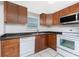 The kitchen has ample counter space, white appliances, and tile flooring at 1965 Louisiana Ave, Englewood, FL 34224
