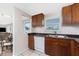 Kitchen features ample wooden cabinetry, white appliances and a window at 1965 Louisiana Ave, Englewood, FL 34224