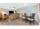 Bright living room with laminate floors, ceiling fan, and dining table for a comfortable living and dining space at 1965 Louisiana Ave, Englewood, FL 34224