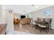 Bright living room with laminate floors, ceiling fan, and dining table for a comfortable living and dining space at 1965 Louisiana Ave, Englewood, FL 34224
