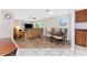 Open-concept living room with a dining area, plush sofa, a ceiling fan, and a sliding glass door at 1965 Louisiana Ave, Englewood, FL 34224