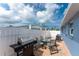 A fenced-in patio with outdoor seating and a grill, perfect for enjoying outdoor meals at 1965 Louisiana Ave, Englewood, FL 34224