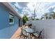 Cozy outdoor patio with a glass table and chairs, perfect for relaxation and outdoor dining at 1965 Louisiana Ave, Englewood, FL 34224