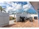 A fenced-in patio with a grill, table, and chairs for outdoor dining at 1965 Louisiana Ave, Englewood, FL 34224
