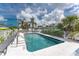 Inviting community pool with lounge chairs and lush palm trees, great for summertime fun at 1965 Louisiana Ave, Englewood, FL 34224