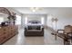 Bright bedroom with tiled floors, a ceiling fan, a couch, and traditional furnishings at 2125 Floribanna St, North Port, FL 34287