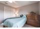 Well-lit bedroom featuring a full-size bed, spacious closet, and a classic wooden dresser at 2125 Floribanna St, North Port, FL 34287